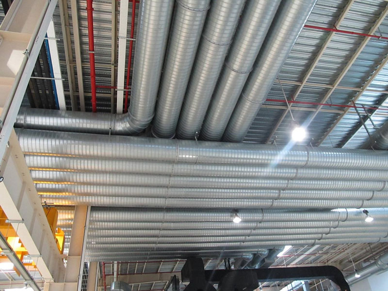 Completed steel industrial facility with rainwater harvesting gutters and ventilation systems