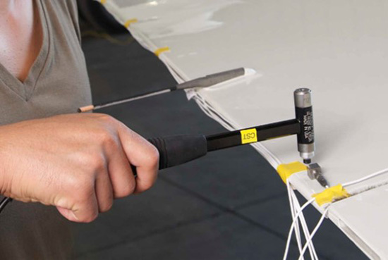 Workers use mechanical hammering to eliminate residual stress after welding steel structure components